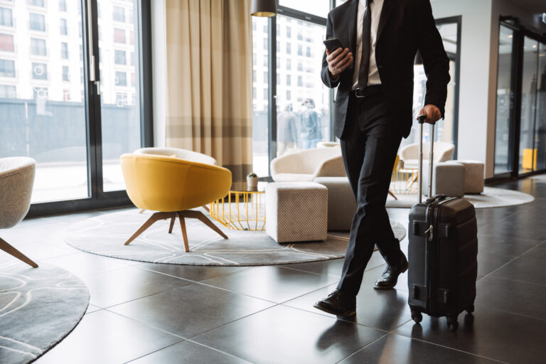 Cropped photo of successful businessman wearing suit holding sma