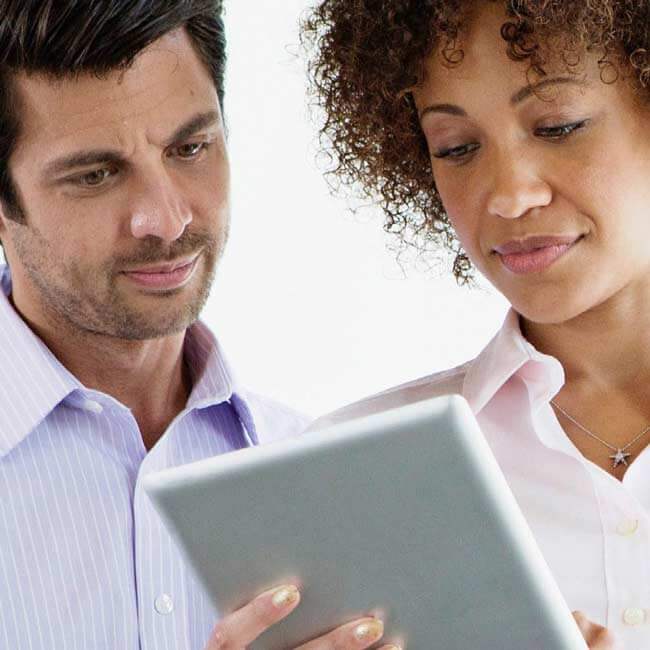 Two people looking at a tablet