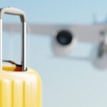 Suitcases with an airplane in the background