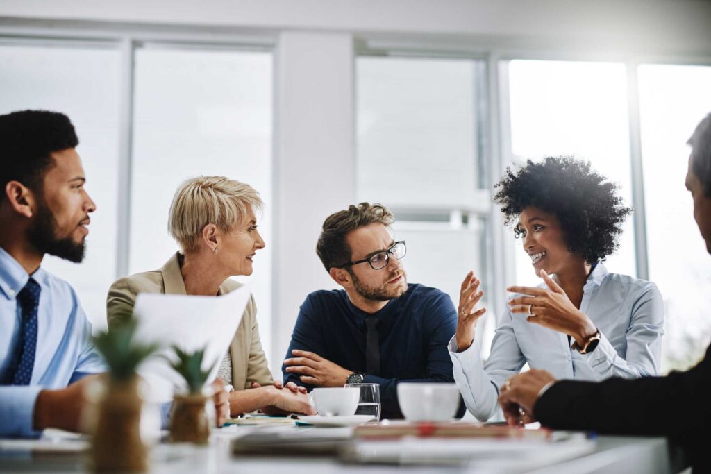 Businesspeople sitting together in a brainstorming meeting