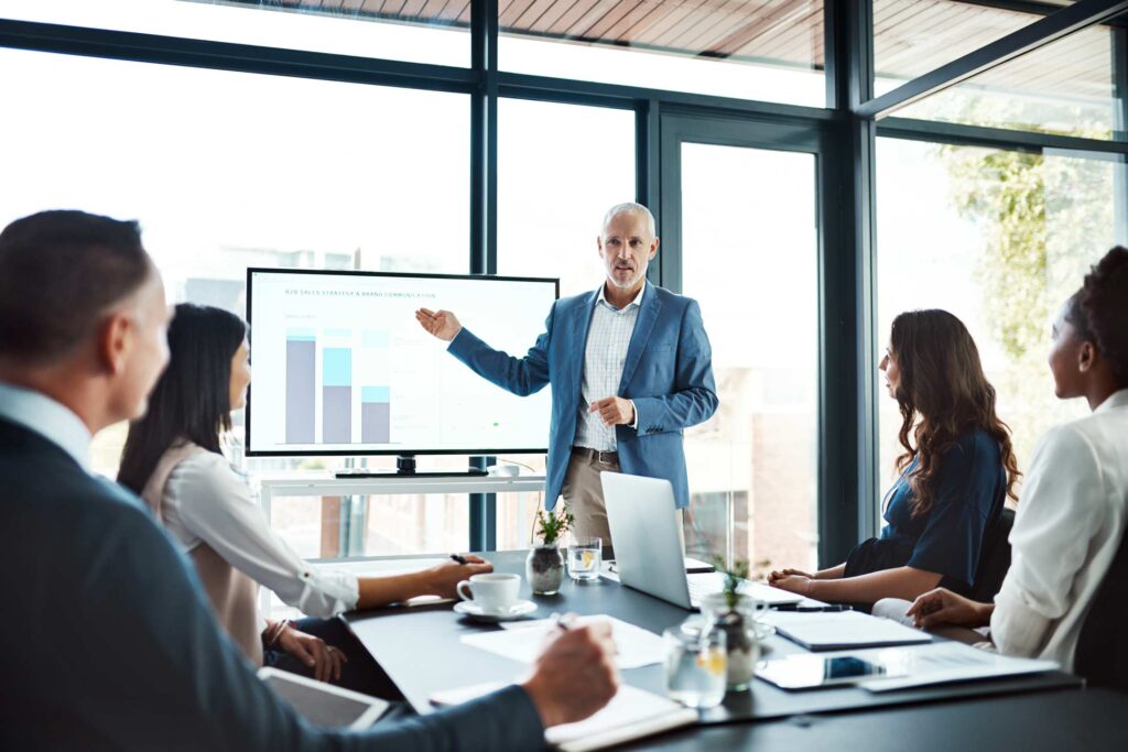 Manager with team of executives in workshop presentation