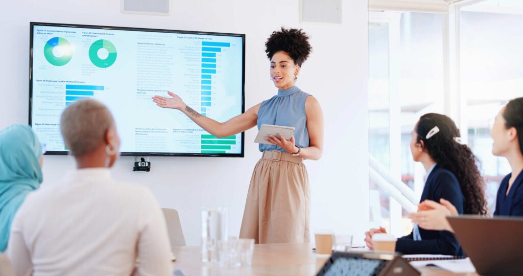 Woman presenting statistics in business meeting
