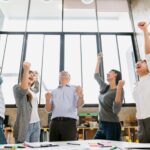 Cheerful group of creative business people winning great success