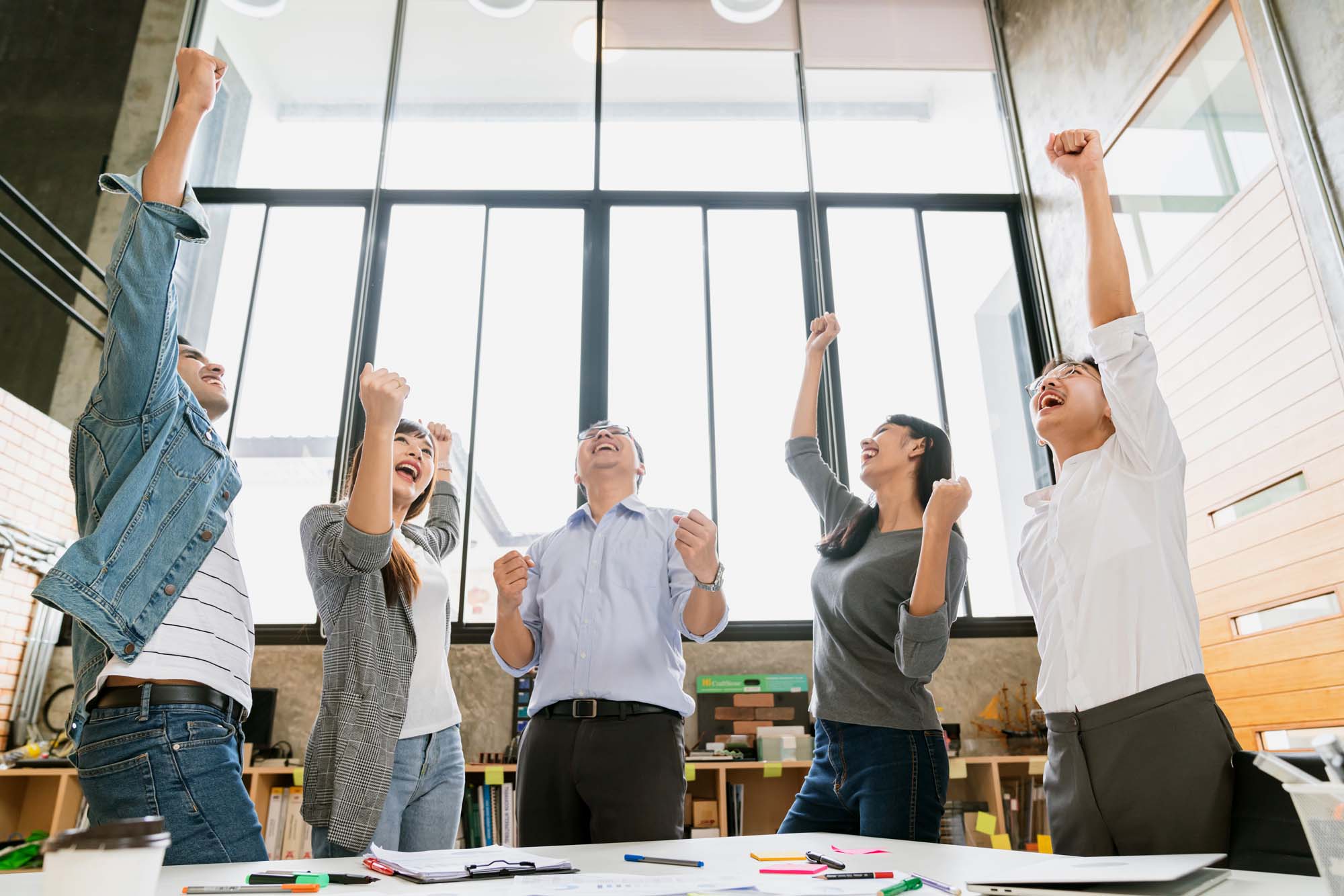 Cheerful group of creative business people winning great success