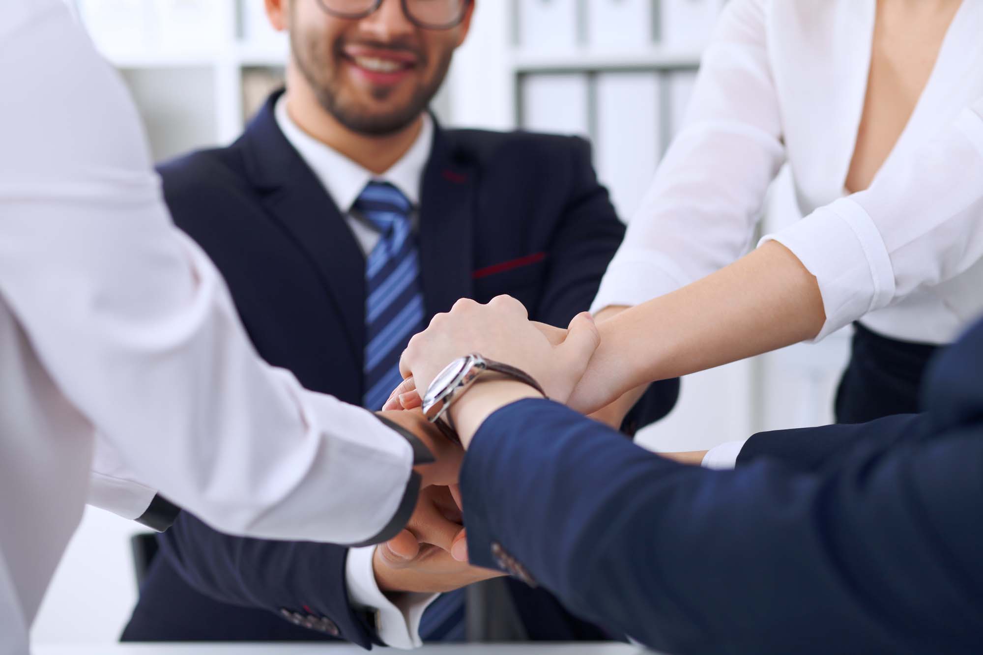 Business people group Business people group happy showing teamwork and joining hands or giving five after signing agreement or contract in office