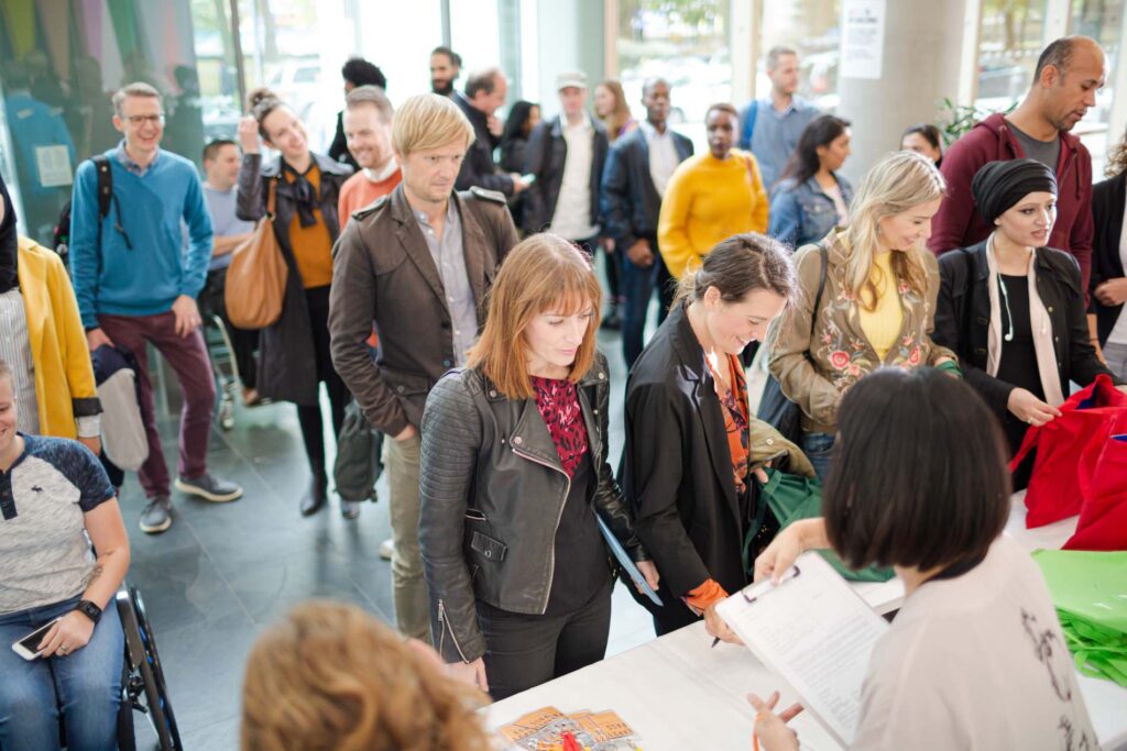 People signing up for conference