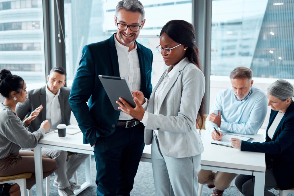 Business people, tablet and conversation with ceo for planning and collaboration in office.