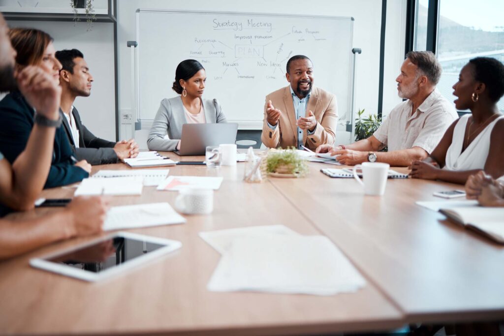 Business people, teamwork and meeting for strategy, planning or corporate brainstorming discussion at office. Group of employees in team collaboration or communication in conference at the workplace