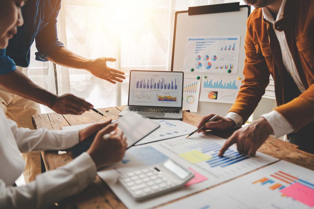 Young colleagues discuss business and analytical price charts us