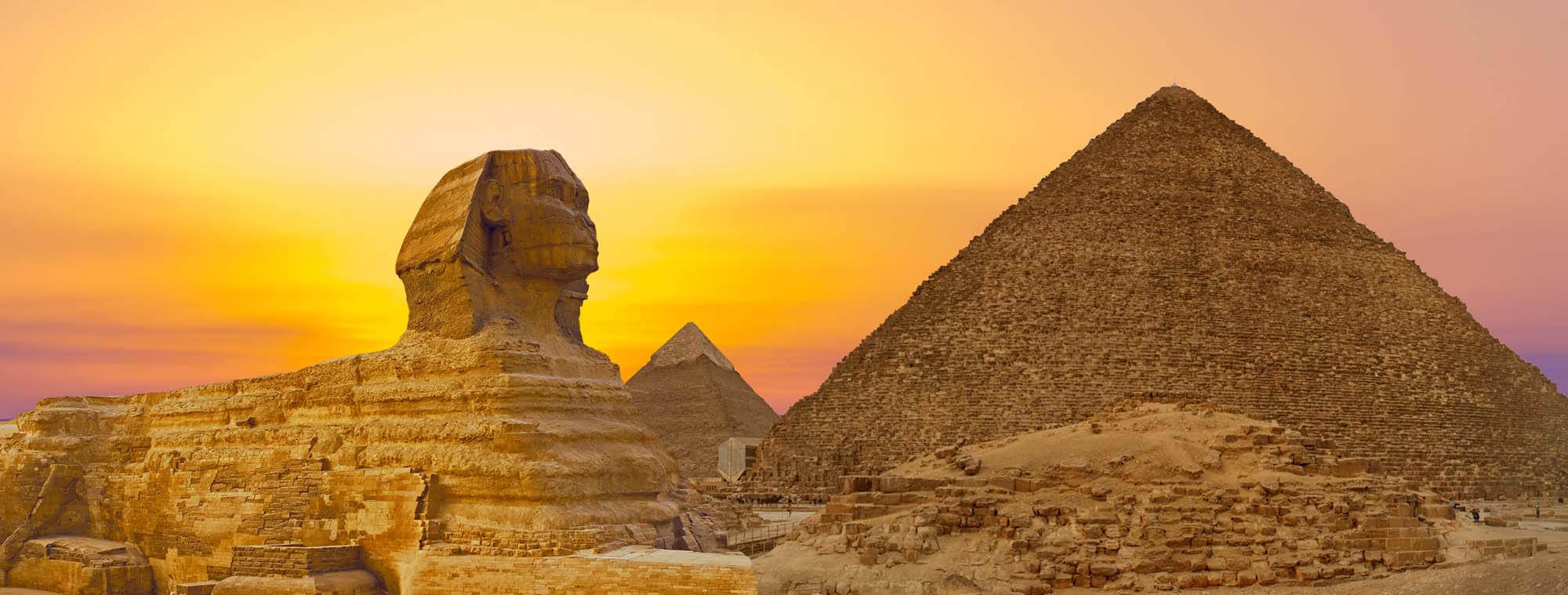 Sphinx against the backdrop of the great Egyptian pyramids.