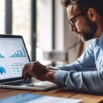 Data analysis to increase sales and revenue. Man sitting with laptop and working with growing graph. Business data analytics concept. Generative ai.
