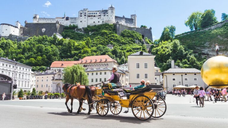 Tourists sightseeing in horse carriage in Salzburg, Austria