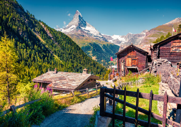 Sunny summer morning in Zermatt village with Matterhorn (Monte Cervino, Mont Cervin) peak on backgroud. Beautiful outdoor scene in  Swiss Alps, Valais canton, Switzerland, Europe.