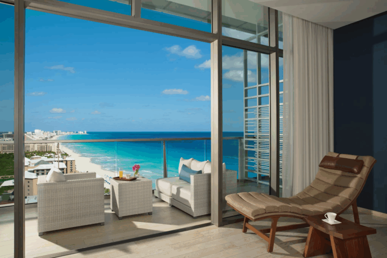 Balcony area of a hotel room overlooking the ocean and beach