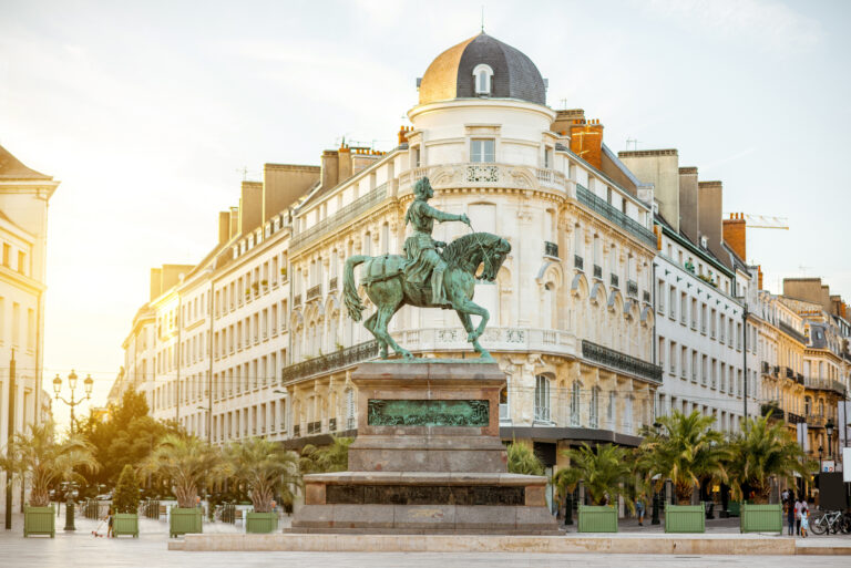 View on the Martroi square with statue of Saint Joan of Arc in Orleans city during the sunset in France