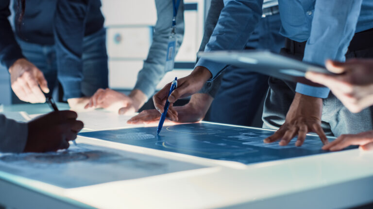 Engineer, Scientists and Developers Gathered Around Illuminated